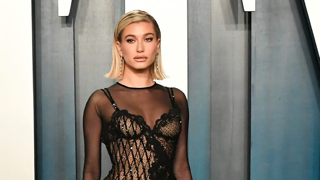 Hailey Bieber wears a mesh black dress on the red carpet