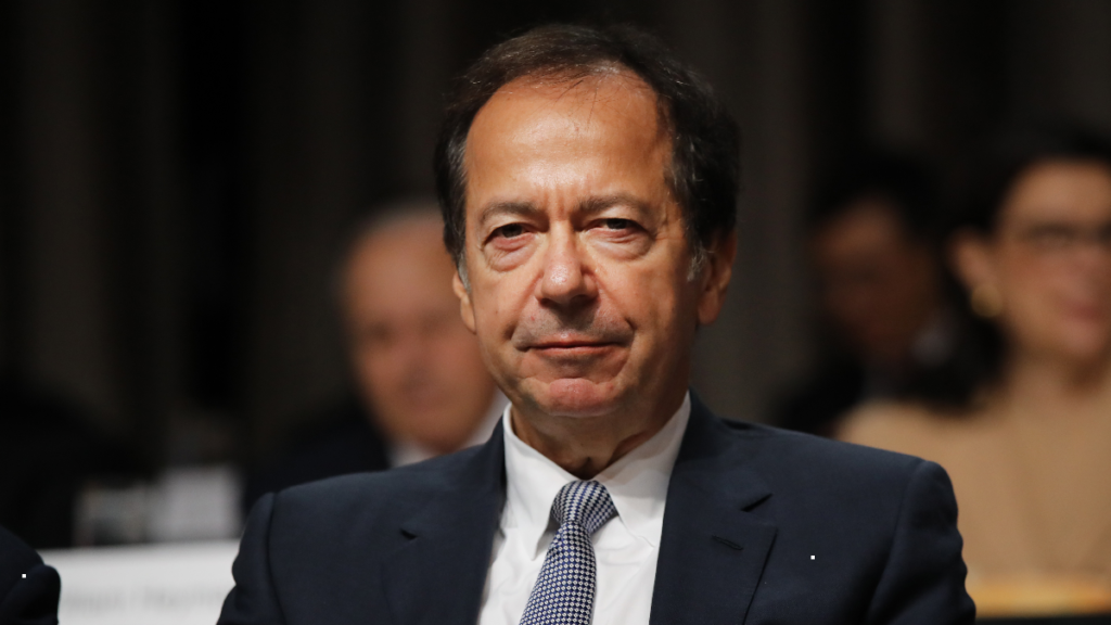 John Paulson wears a dark suit during an economic speech