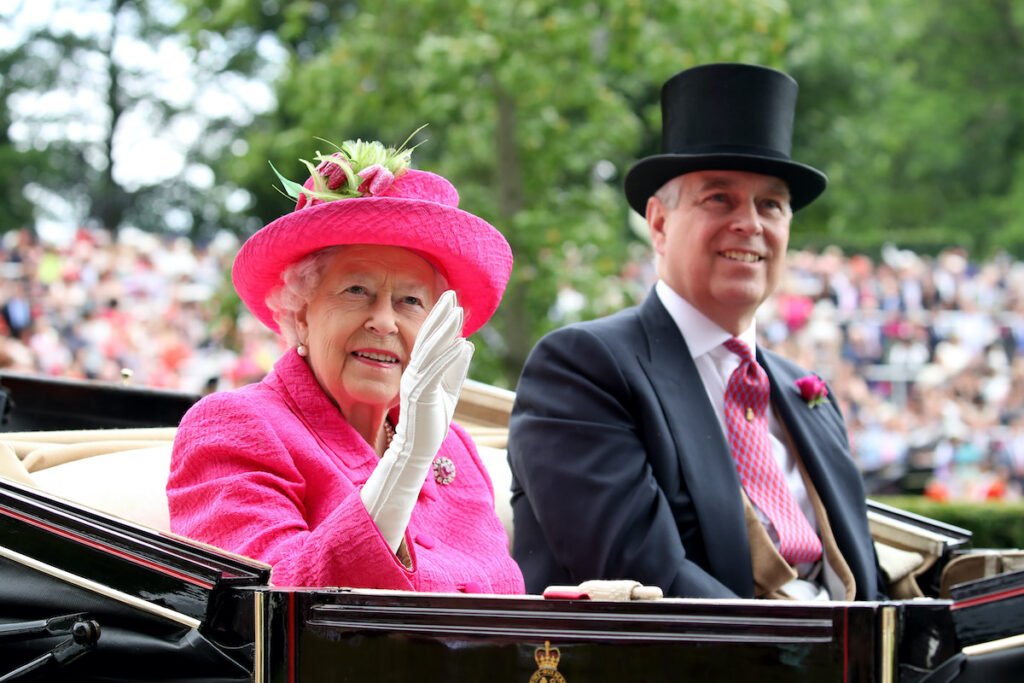 Queen Elizabeth in pink with Prince Andrew in a black suit