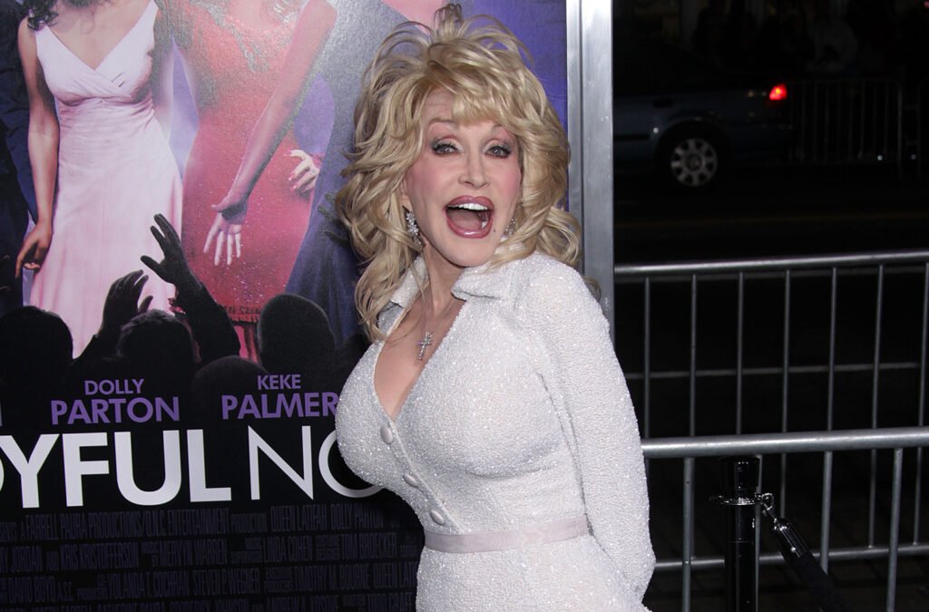 Dolly Parton in all white, with her mouth agape