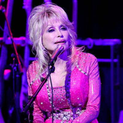 Dolly Parton on stage in a pink outfit