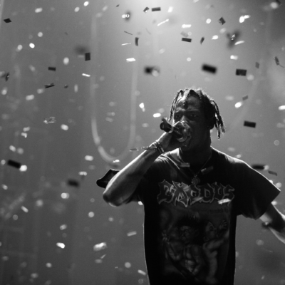 Travis Scott at a concert with glitter falling from the ceiling