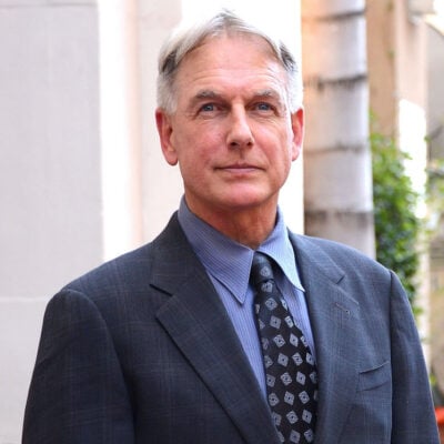 Mark Harmon smiling in a grey suit