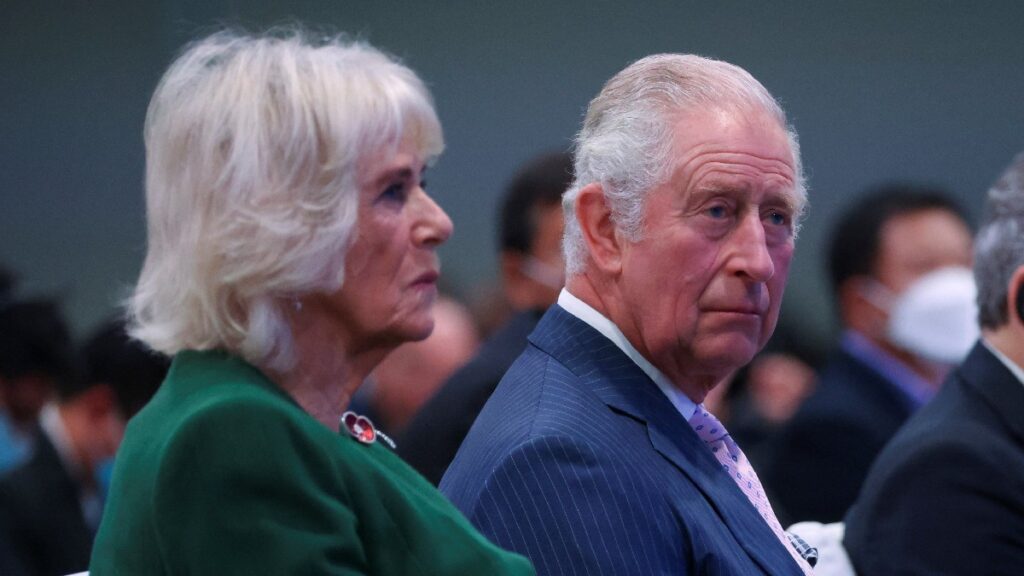 Camilla Parker Bowles, in green, sits beside husband Prince Charles, in a blue suit, at the COP26 Summit