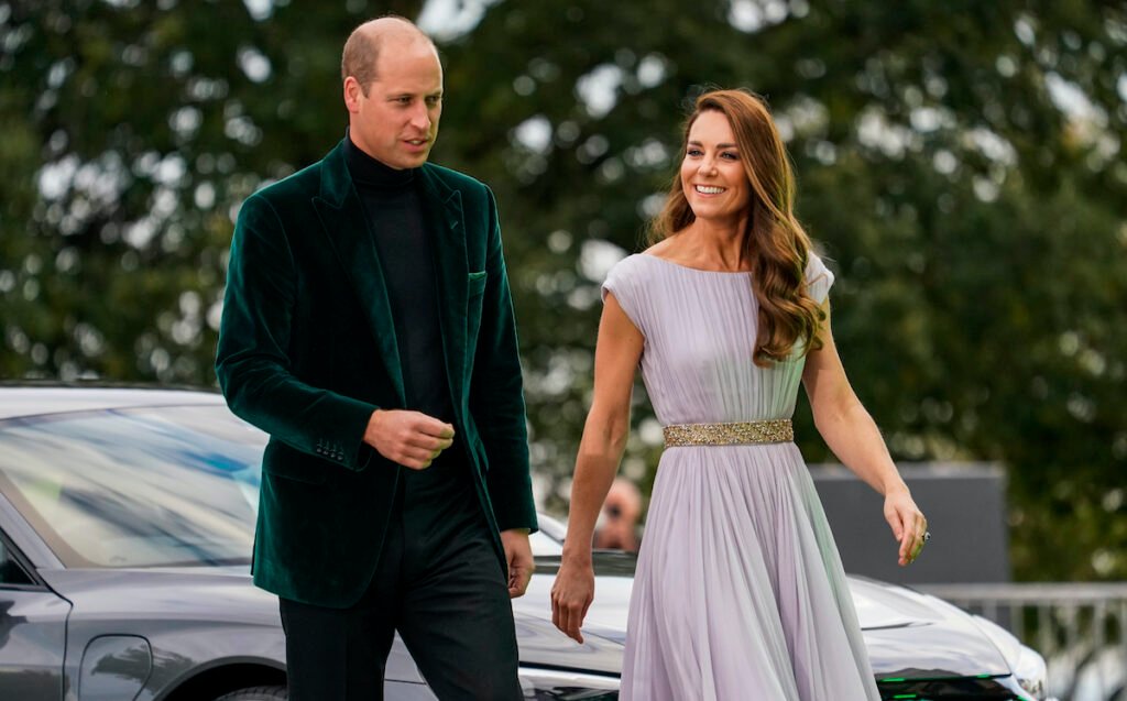 Prince William in a green suit with Kate Middleton in a white dress