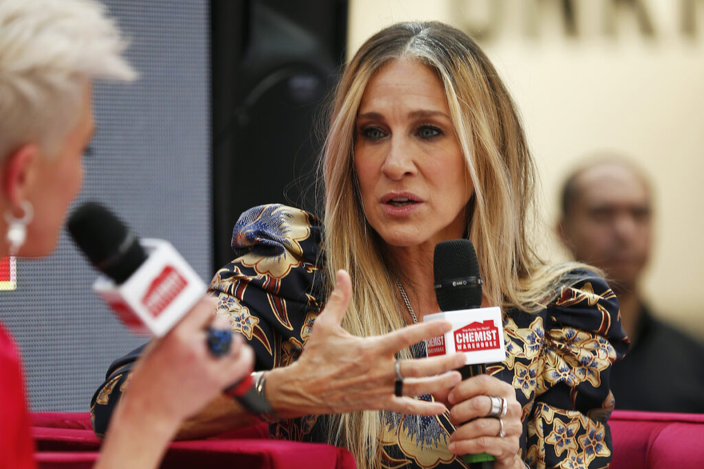 Sarah Jessica Parker speaking into a microphone sitting down