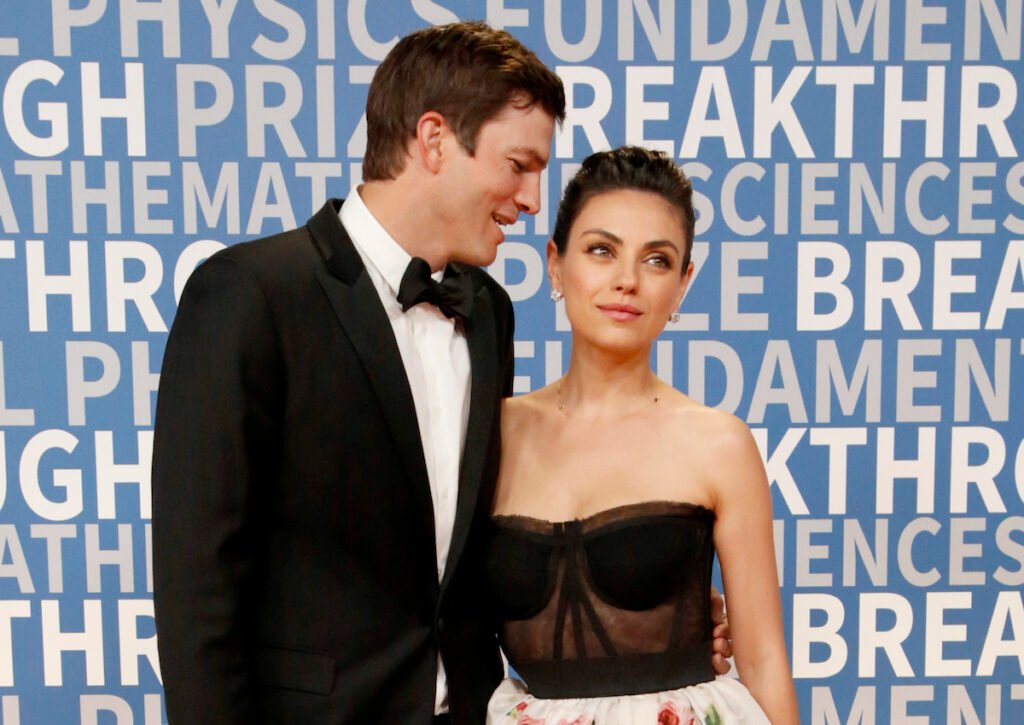 Ashton Kutcher in a tux with Mila Kunis in a dress