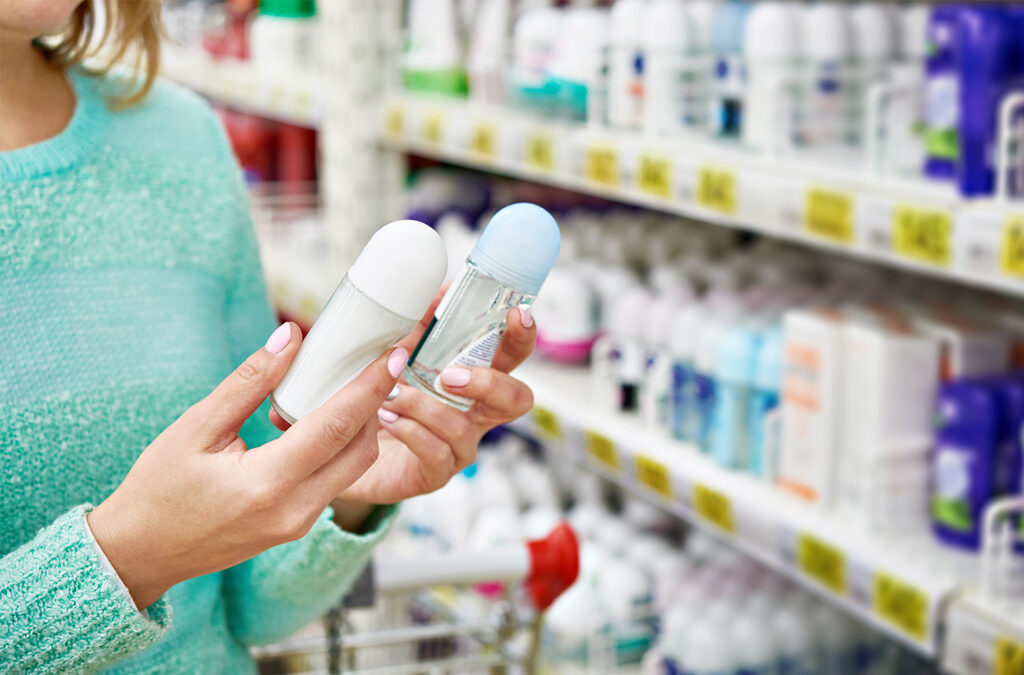 A woman looking a deodorant at a supermarket