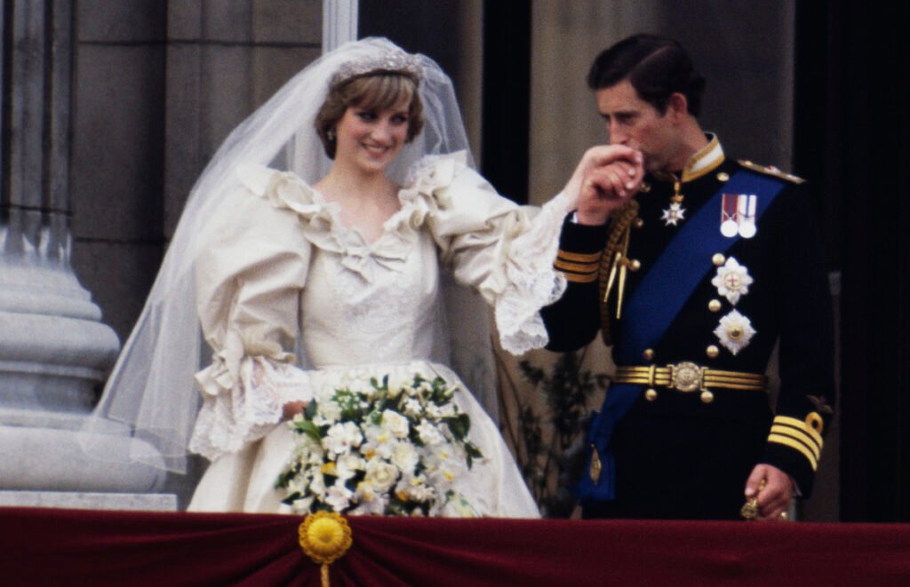 Princess Diana in her wedding gown with Prince Charles in a navy suit