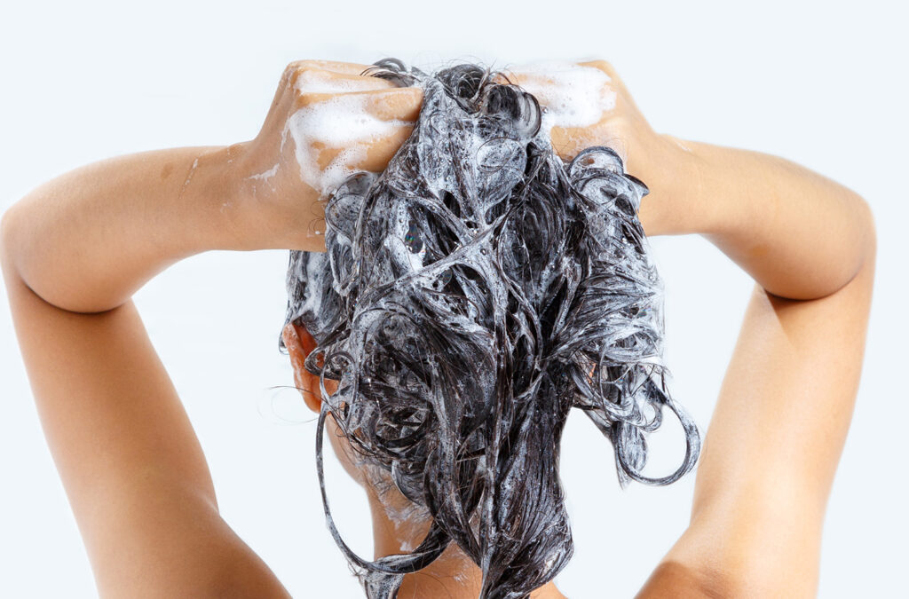 A woman washing her hair, seen from behind