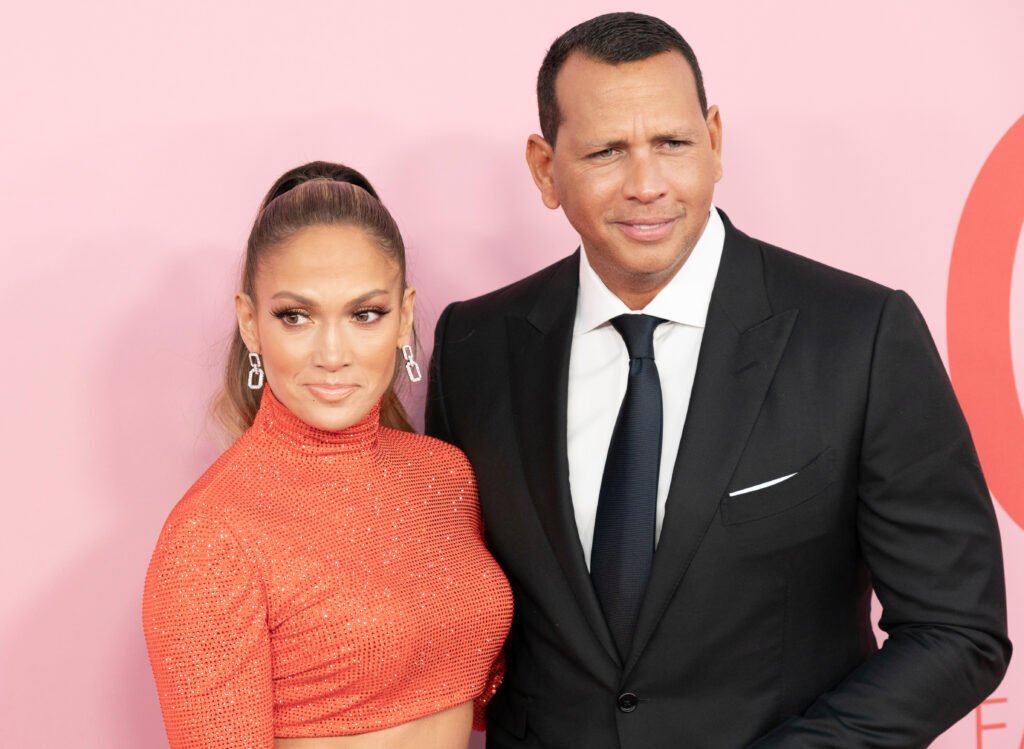 Jennifer Lopez in a pink dress with Alex Rodriguez in a suit