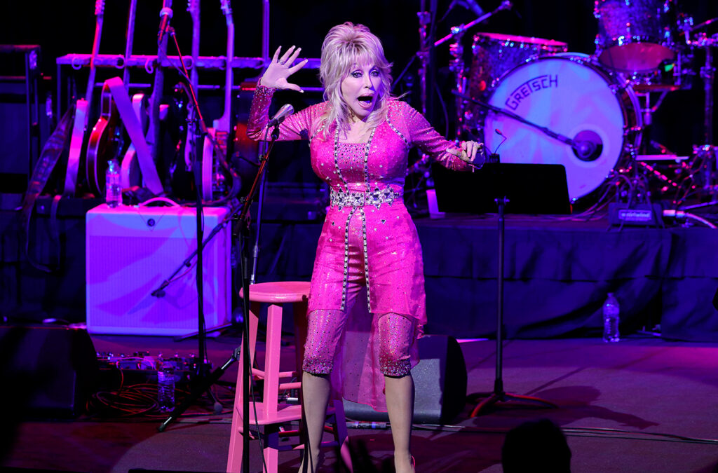 Dolly Parton performing in all pink in 2021