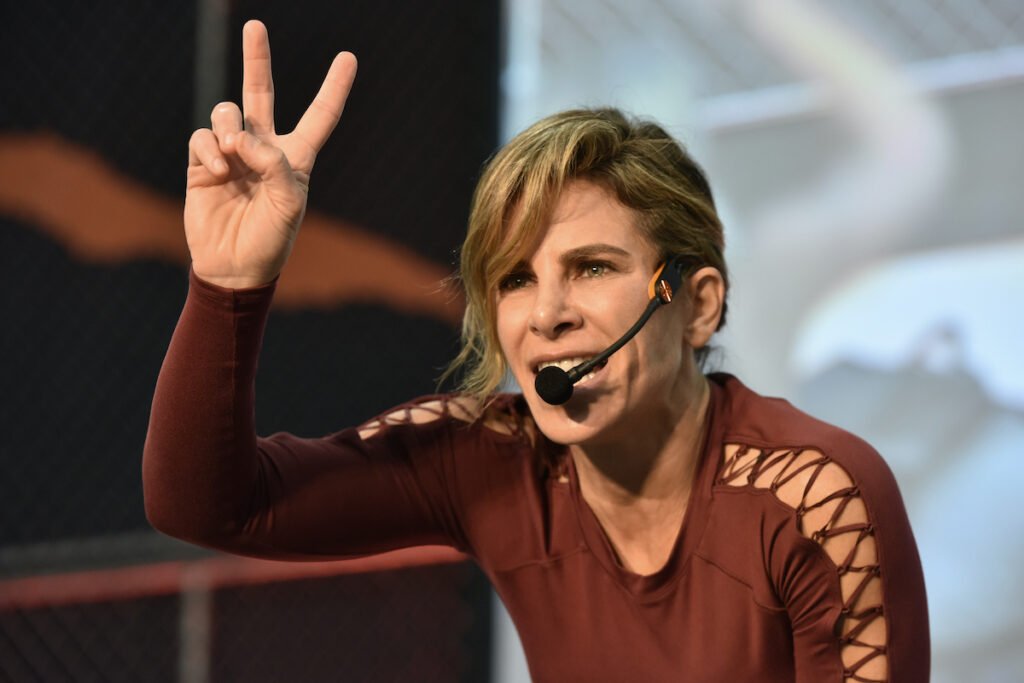 Jillian Michaels on stage in a red top