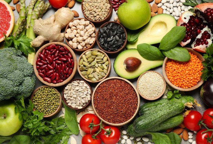 Healthy foods - seeds, nuts, beans, broccoli, cucumbers, apples, avocado, tomatoes