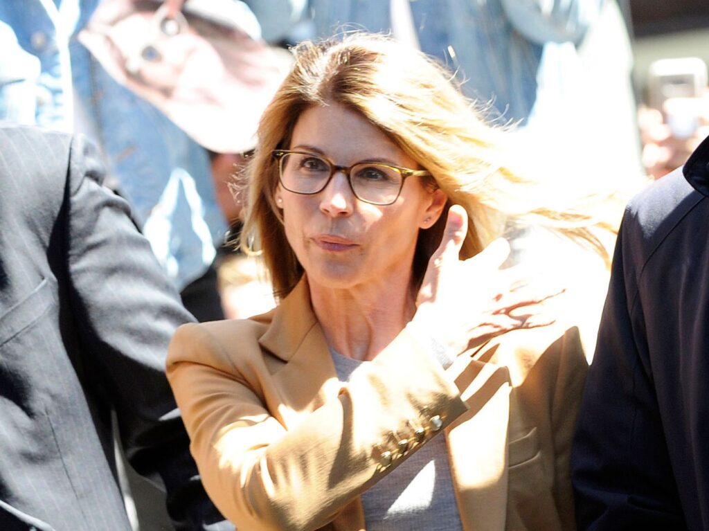 2019 photo of Lori Loughlin in a brown suit walking out of court