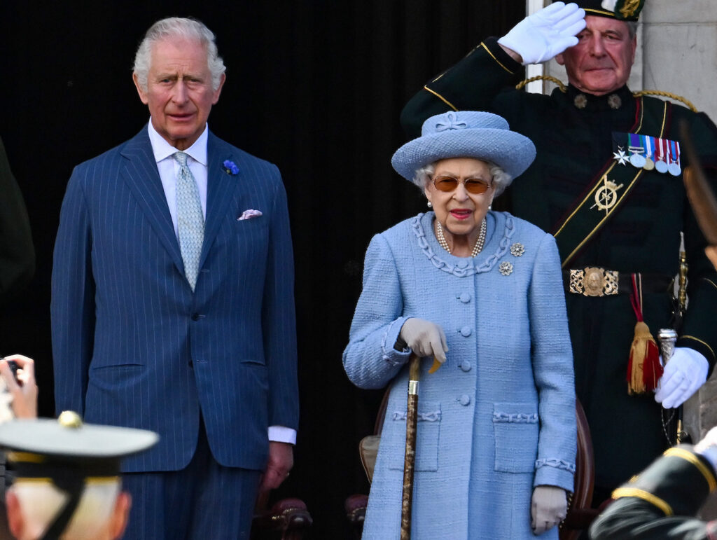 Prince Charles in a blue suit with Queen Elizabeth in a blue outfit
