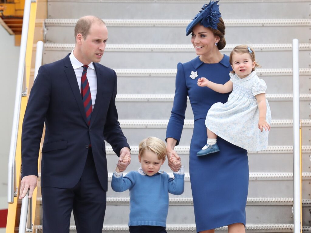 (L-R): Prince William, Prince George, Kate Middleton, and Princess Charlotte stepping off a plane