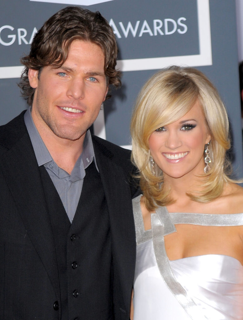 Carrie Underwood (R) in white gown and Mike Fisher in black suit