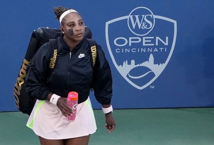 Serena Williams before game with gear pack and water bottle