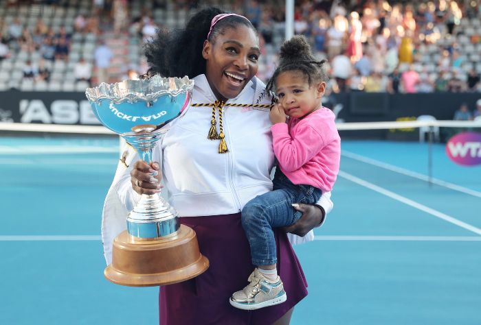 Serena Williams holds daughter Olympia with trophy
