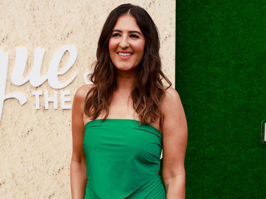 D'Arcy Carden smiling in green dress