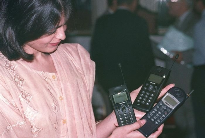 Woman models 1980s cell phone models