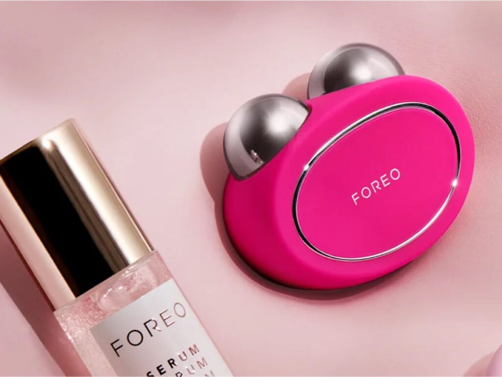 A magenta FOREO BEAR and their SERUM SERUM SERUM