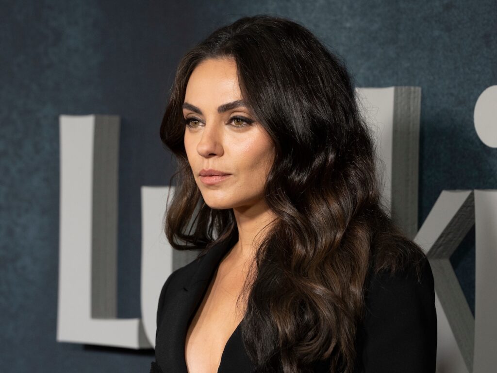 close up photo of Mila Kunis in a black jacket