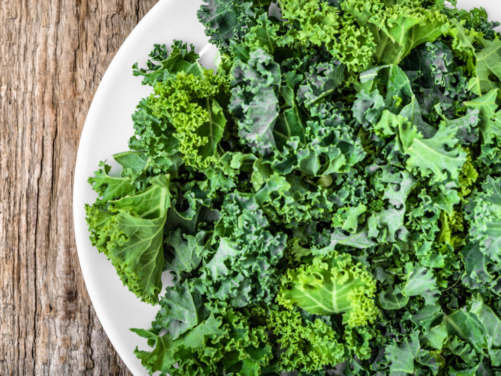 A white plate of raw kale