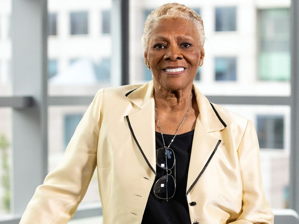 Dionne Warwick smiles in black shirt with cream-colored blazer