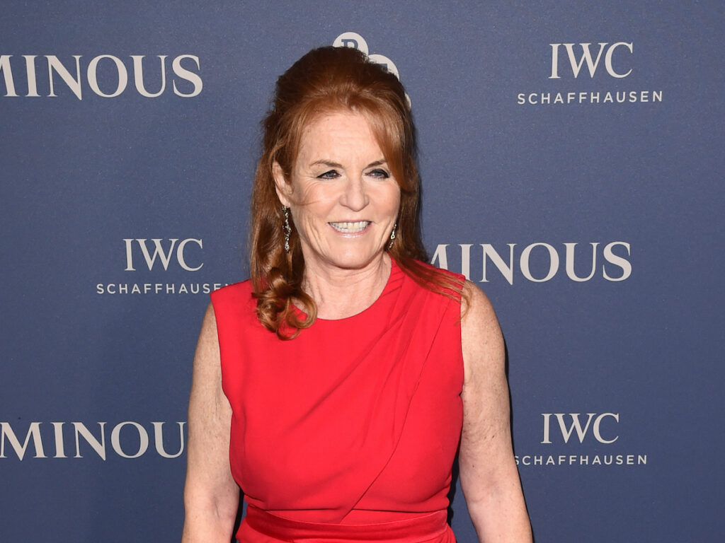 Sarah Ferguson smiling in a red dress in 2019