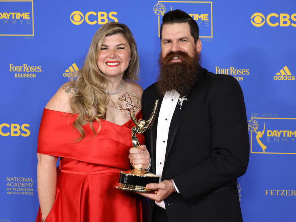 Candis and Andy Meredith holding an Emmy together