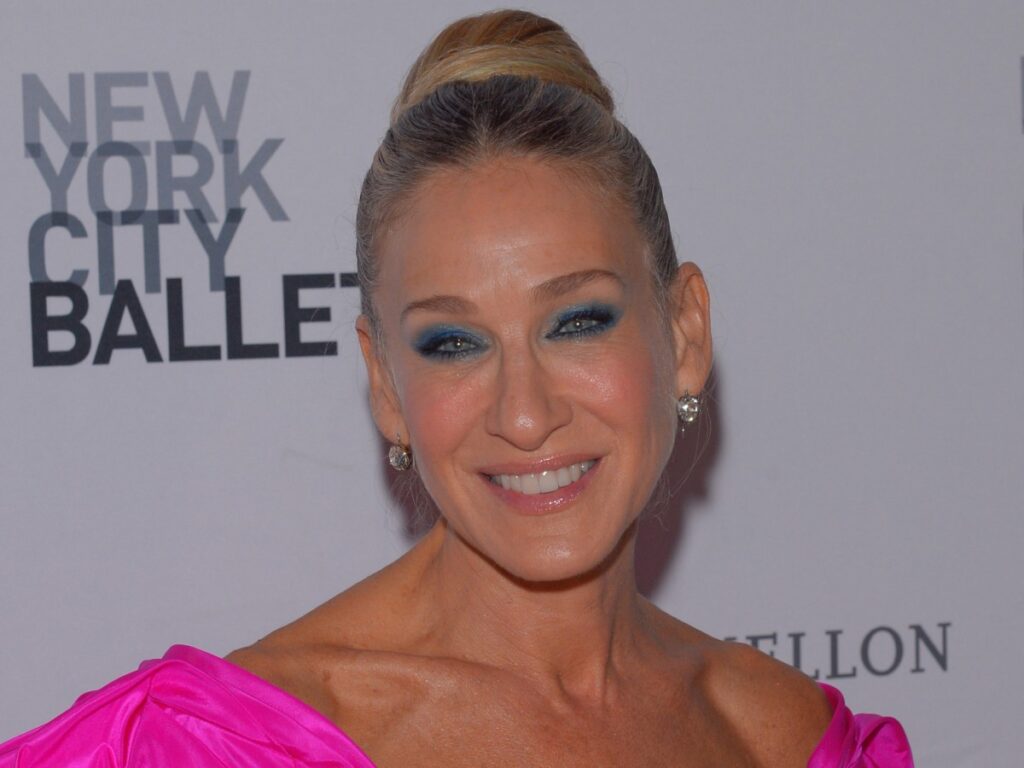 Sarah Jessica Parker smiles in hot pink dress