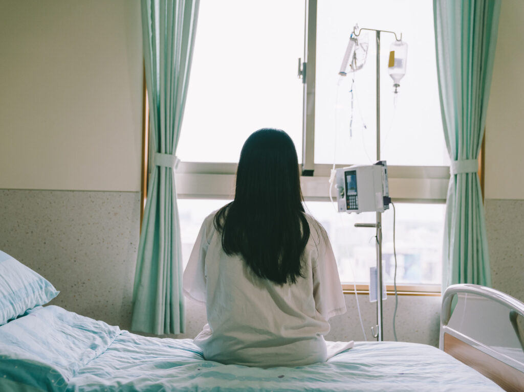 A woman sitting on a hospital bed